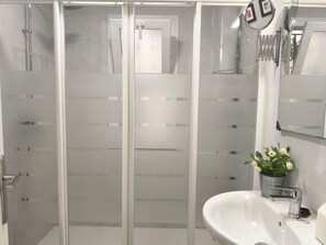 Shower, hair dryer, towels, toilet paper