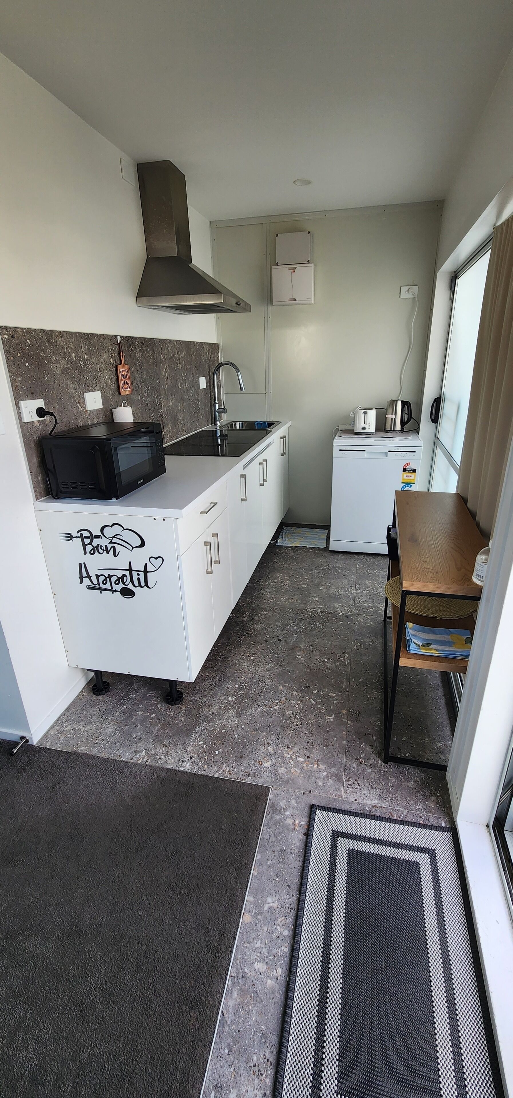 A compact kitchen with a microwave, toaster, and coffee maker.