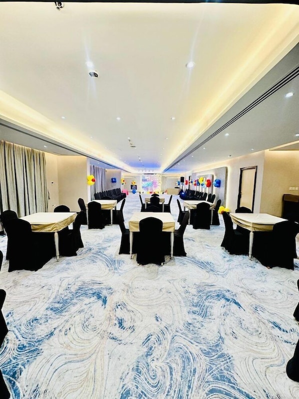 A hotel conference room with tables and chairs arranged for meetings. - Wescott Plaza Hotel Apartments L.l.c (Dubai)