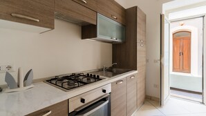 A modern kitchen with a gas stove, built-in oven, and a microwave. - 'Corso Roma Home Gallipoli' Apartment with Air Conditioning (Gallipoli)