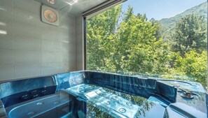 A spa room with a large window, a bathtub, and a shower area. - Gapyeong Funny Mongmong Galaxy House (Gapyeong)