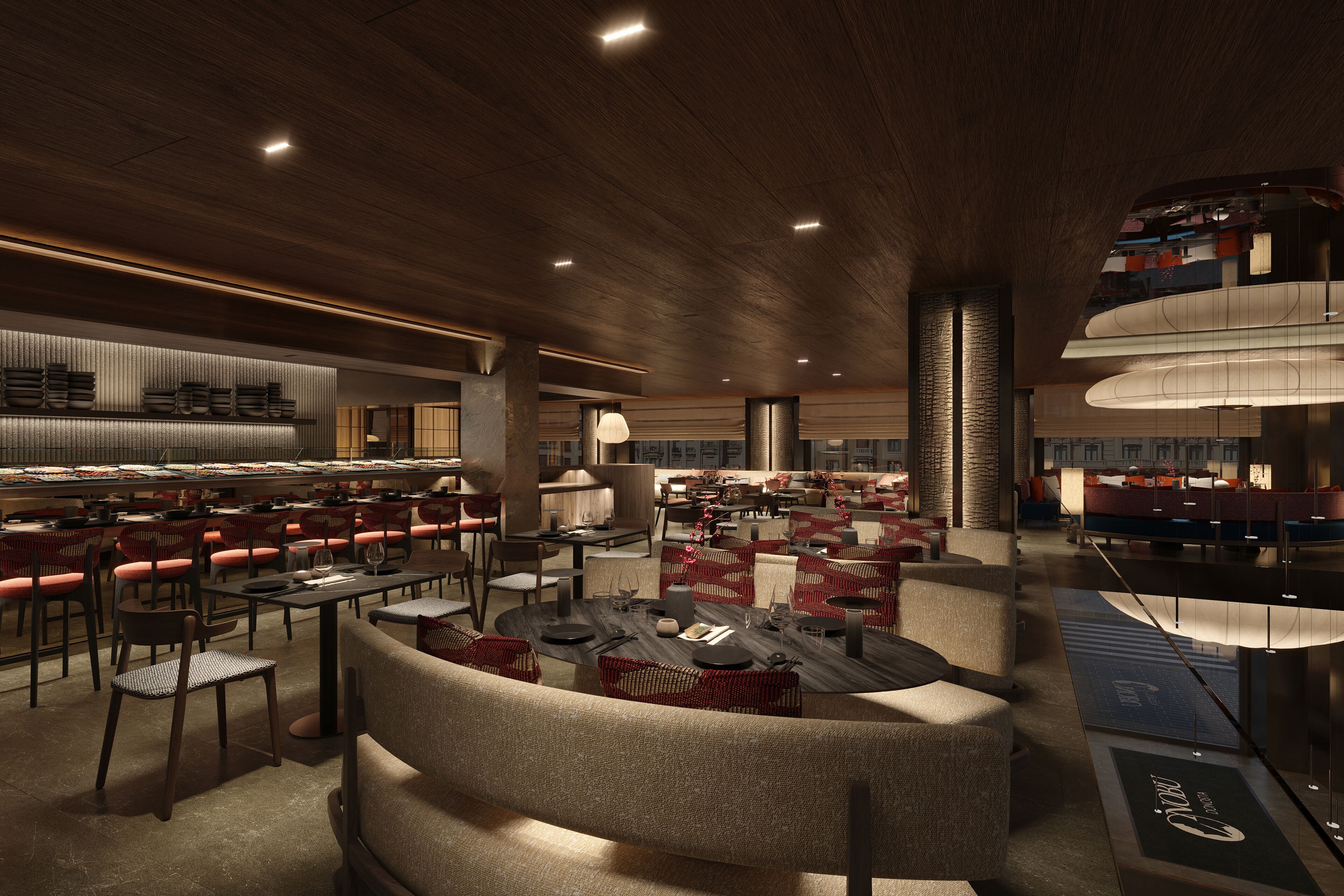 A spacious restaurant with multiple dining areas, including a central seating area with round tables and red chairs, and a bar area with high stools.