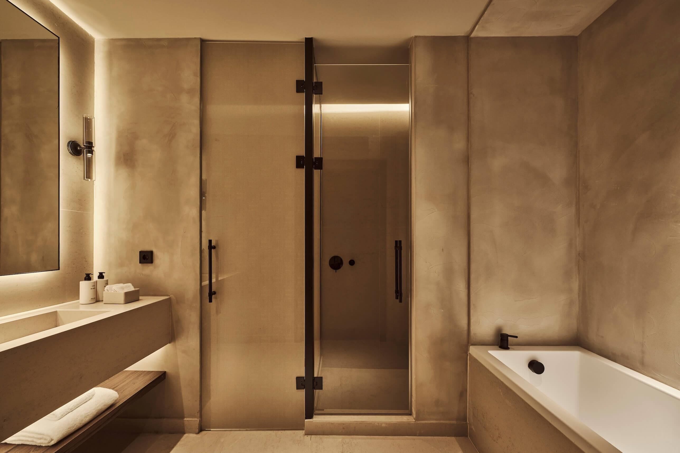 A modern bathroom with a walk-in shower, a bathtub, and a vanity with a mirror.
