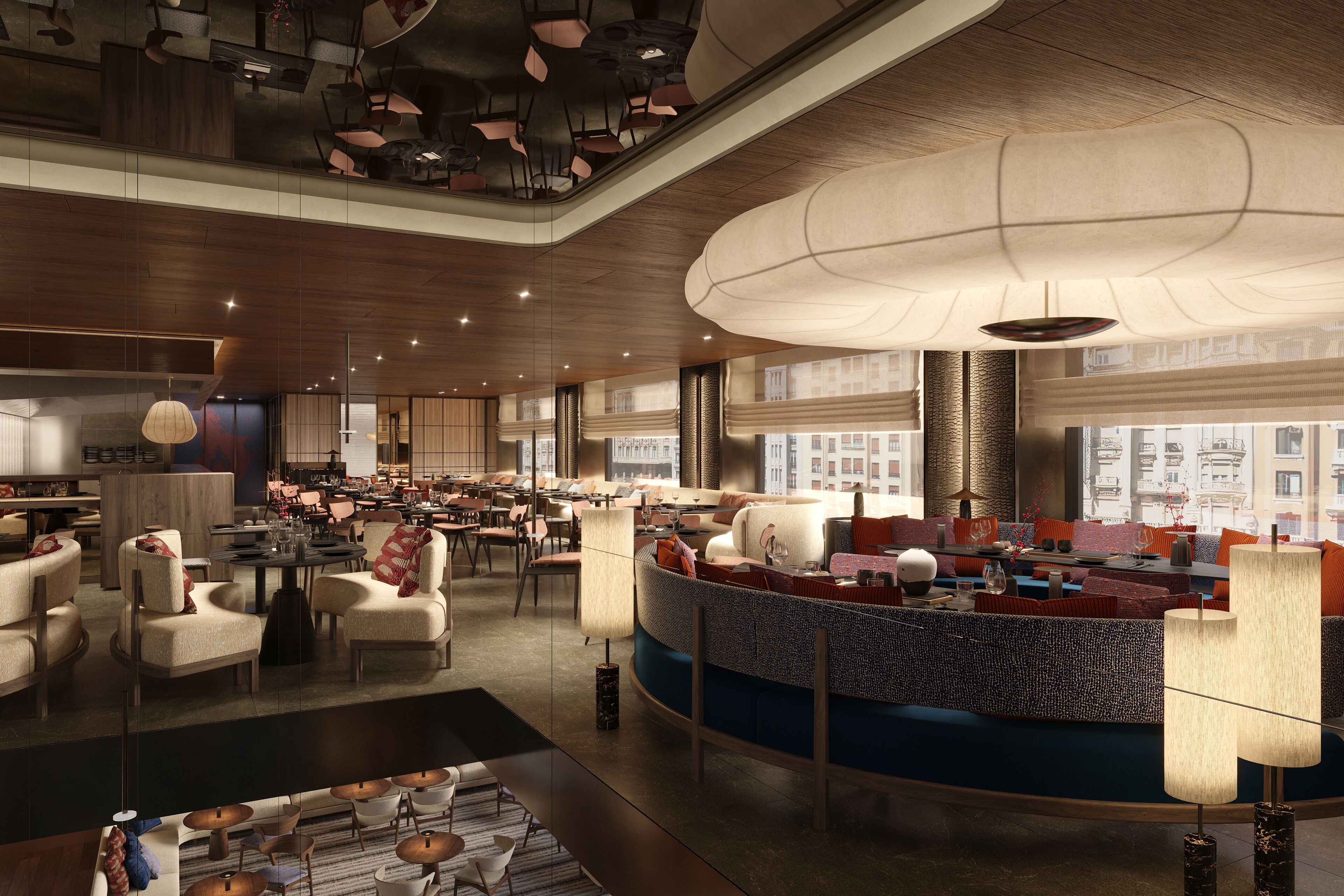 A spacious hotel lobby with a central seating area, multiple tables, and a high ceiling with unique lighting fixtures.
