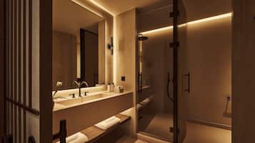 A modern bathroom with a large mirror, dual sinks, a shower enclosure, and a wooden vanity.