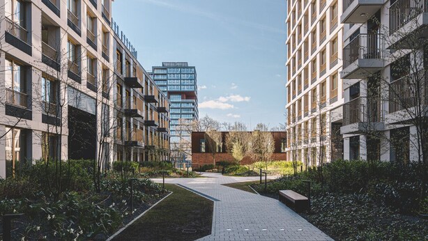 Een modern woongebied met meerverdiepingen, een centrale route en groen.