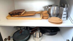 A kitchen with a wooden cutting board, grater, and cork coasters. - Premium Comfort Living | Elegant 2BR Apartment (Larnaca)