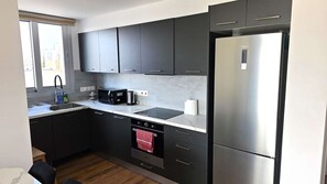 Køleskab, mikrobølgeovn, kogeplade, køkkentøj/tallerkener/redskaber