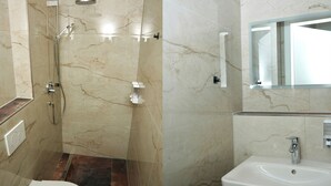 A bathroom with a shower, toilet, sink, and mirror. - Mersa Hotel (Backnang)
