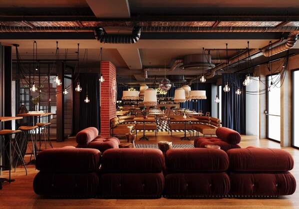 A modern interior with a central seating area, exposed ductwork, and hanging pendant lights. - Docas Hotel Lisbon (Lisbon)