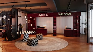 A modern interior with a reception desk, check-in area, and seating with geometric cushions. - Docas Hotel Lisbon (Lisbon)