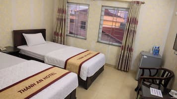 Deluxe Triple Room, City View | Desk, blackout curtains