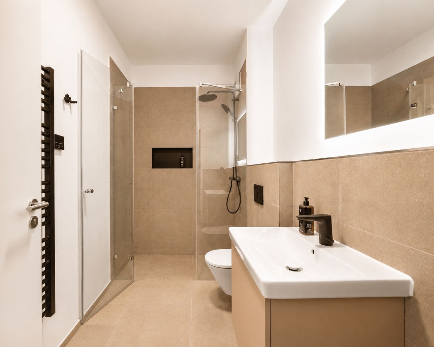 A modern bathroom with a shower, toilet, and sink.
