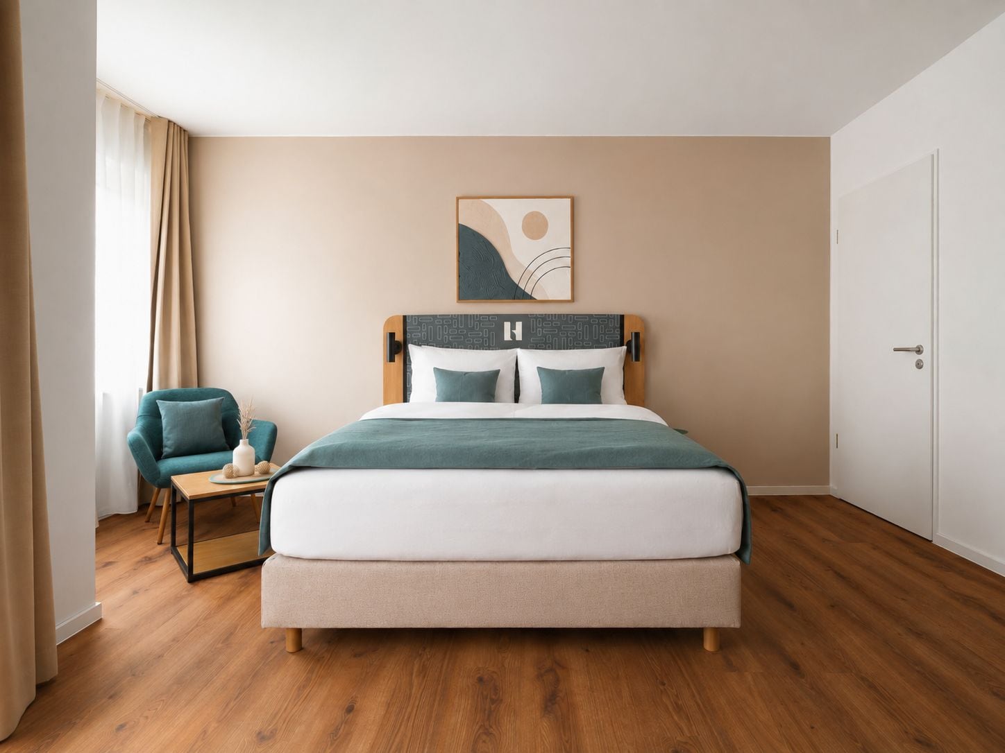 A hotel room with a bed, a chair, a small table, and a door.