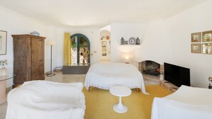 A hotel room with two beds, a television, a fireplace, and a small table. - Villa with Pool 700 Meters from the Beach (Begur)