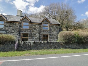 A stone house with three windows and a stone wall. - Ysgoldy (Dolwyddelan)