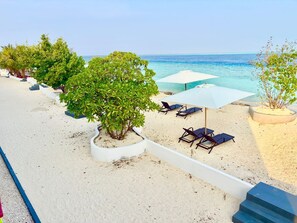 A beachside resort with lounge chairs, umbrellas, and a clear view of the ocean. - Maduvvaree Waterfront Sands (Maduvvari)