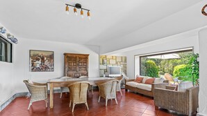 A spacious room with a dining area, a sofa, and a television. - Holiday Home 'Finca Tolombreo Casa Gabriel' in Cudillero (Cudillero)
