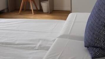 Un dormitorio con cama, escritorio y silla.