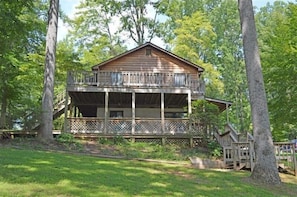 A wooden cabin with a balcony, surrounded by trees. - Come Visit "Pirate's Roost'!  Pet Friendly! 2-3 Night Minimum! (Moneta)