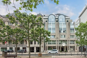 A building with a modern entrance, large windows, and a sign that reads "Garnier."