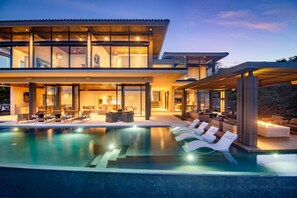 A modern house with a swimming pool, lounge chairs, and a covered outdoor seating area. - Kupuri 32 In Kupuri Punta Mita (Punta de Mita)