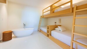 A bunk bed room with a bathtub, a ladder, and a wooden ladder for the upper bunk. - Casa Brisa in Punta Mita (Punta de Mita)