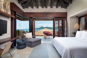 A modern bedroom with a large bed, a sofa, a chair, and a TV. - Casa Milagro Diario - Mita Residential Punta Mita (Punta de Mita)