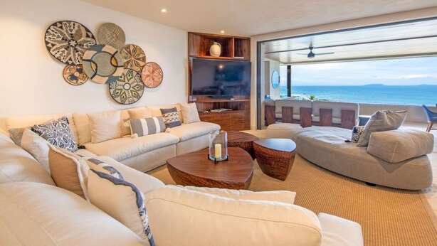A modern living room with a sofa set, coffee table, and decorative wall art. - Condo Las Olas in Punta Mita (Punta de Mita)
