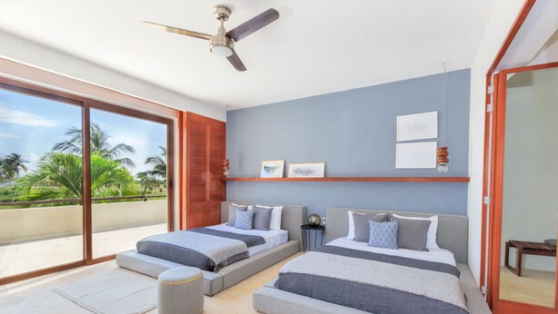 A modern bedroom with two beds, a ceiling fan, a sliding glass door to a balcony, and a view of palm trees. - Condo Terramar in Punta Mita (Punta de Mita)