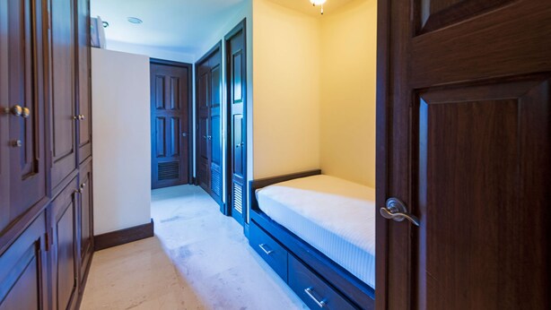 A bedroom with a bed, a wardrobe, a door, and a ceiling light. - Condo Clavel in Punta Mita (Punta de Mita)