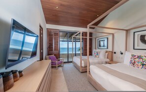 A modern hotel room with a large TV, a bed with a canopy, a desk, and a view of the ocean. - Penthouse Bugambilia (Punta de Mita)