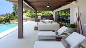 A covered outdoor area with a pool, lounge chairs, and a barbecue grill. - Casa Rincon del Mar in Punta Mita (Punta de Mita)