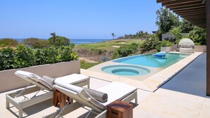 An outdoor pool area with lounge chairs and a view of the ocean. - Casa Rincon del Mar in Punta Mita (Punta de Mita)