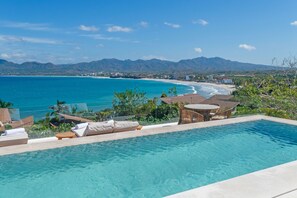 A pool with lounge chairs and a view of the ocean and mountains. - Casa Yeiya in Punta Mita (Punta de Mita)