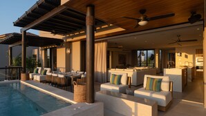 A poolside area with outdoor seating, a ceiling fan, and a view of the interior. - Condo La Joya in Punta Mita (Punta de Mita)