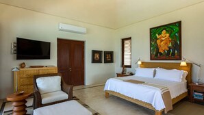A bedroom with a bed, a television, a painting, a desk, and a chair. - Casa Familia in Punta Mita (Punta de Mita)