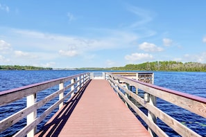 A wooden pier extending into a lake with a clear sky above. - Bahama Bay Resort - Ground Floor (Davenport)