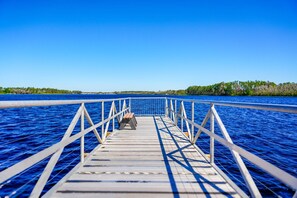 A wooden pier extending into a body of water with a clear sky above. - Bahama Bay Resort Penthouse w Lake View 15209 (Davenport)