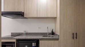 Eine Küche mit Granit Arbeitsplatten, einem Geschirrspüler, einer Kaffeemaschine und Holzschränken.