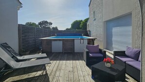 A wooden deck with a pool table, lounge chairs, and a hot tub. - Welcome to Les Renaudelles (Angles)