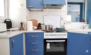 A kitchen with a stove, oven, and various appliances. - Alexandros Luxury Apartments Nydri (Lefkada)