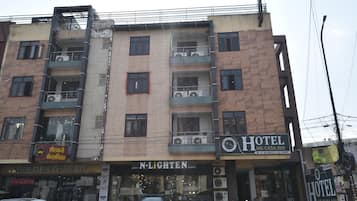 A multi-story building with a hotel named 'Hotel Me-Casa Inn' on the ground floor.