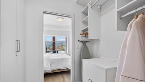 A bedroom with a bed, a wardrobe, a mirror, and a view of the outdoors. - Spectacular View 1 Bdrm 202 At Amenity Filled Resort (West Kelowna)