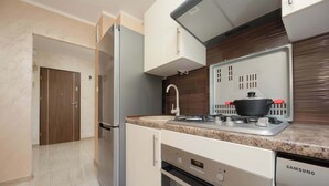 A modern kitchen with a stainless steel refrigerator, a built-in oven, and a Samsung dishwasher. - Cozy Apartment with Balcony | Workspace (Warszawa)