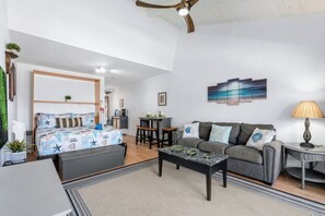 A modern living room with a bed, sofa, dining table, and a ceiling fan. - 2nd floor, updated studio, across from the beach! - Kihei Bay Surf A207 (Kihei)
