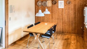 A wooden dining table with chairs, pendant lights, and wall decor. - 3 bedroom stunning home in Bedsted Thy (Bedsted Thy)