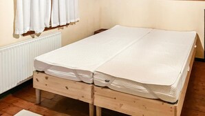 A wooden bed with a mattress and a pillow. - 3 bedroom stunning home in Bedsted Thy (Bedsted Thy)