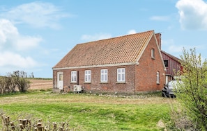 A red brick house with a tiled roof, a front door, and a garage. - Awesome home in Bedsted Thy (Bedsted Thy)