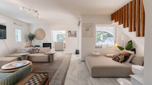 A modern living room with a sofa, coffee table, and a TV.